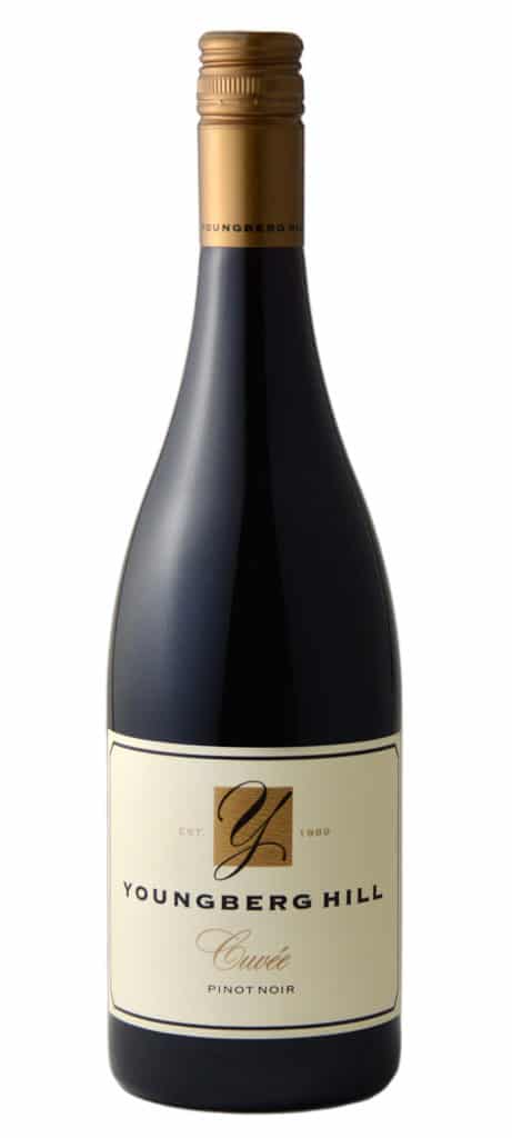 A dark glass wine bottle with a gold screw cap and a cream label reading "Youngberg Hill Cuvee."