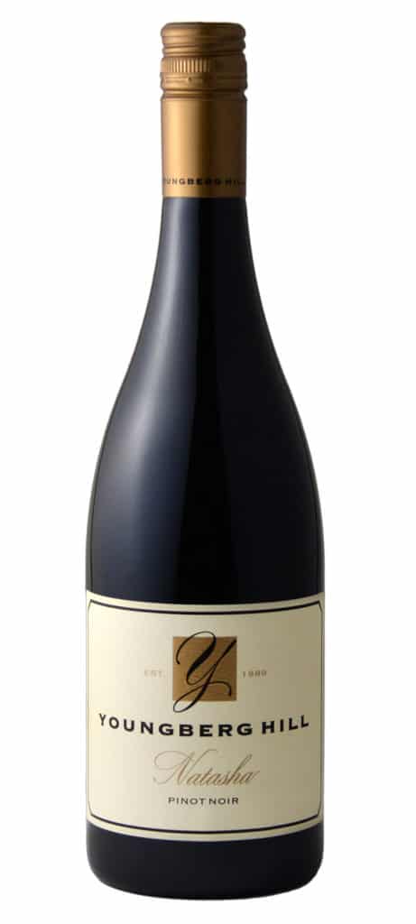A bottle of Youngberg Hill Natasha Pinot Noir with a gold-colored screw cap on a white background.