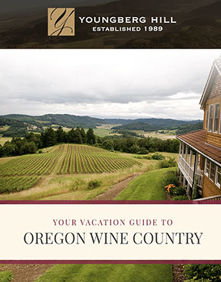 A vacation guide cover for Youngberg Hill, featuring a winery building overlooking vineyards and rolling hills.