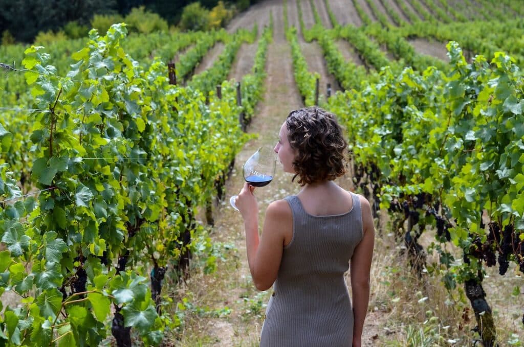 10 Best Wineries in the Willamette Valley to Try in 2023 1 wineries in the Willamette Valley, beautiful woman wine tasting in the vineyards in Oregon