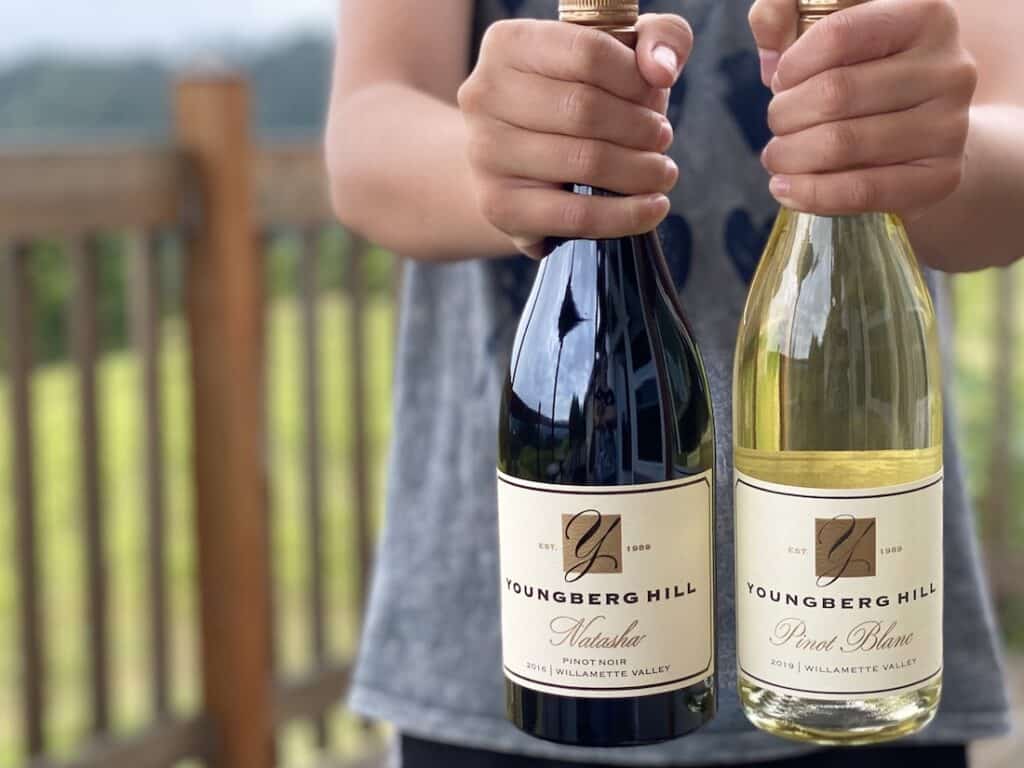 Best Time to Visit Oregon Wine Country, photo of white and red wine bottles from our Willamette Valley winery